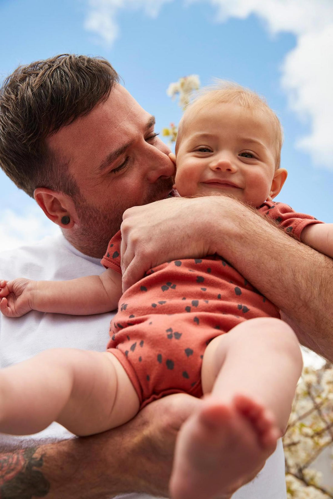 handsome man holding his cute little baby
