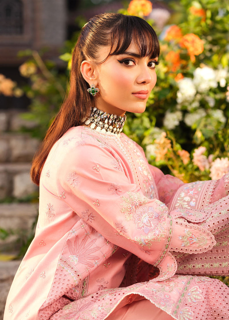 Woman in a pink traditional outfit with floral background