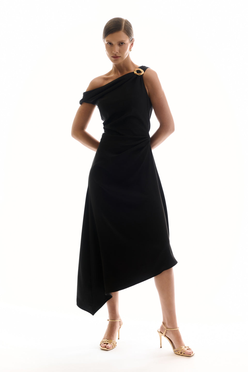 Woman wearing a black one-shoulder dress on a white background