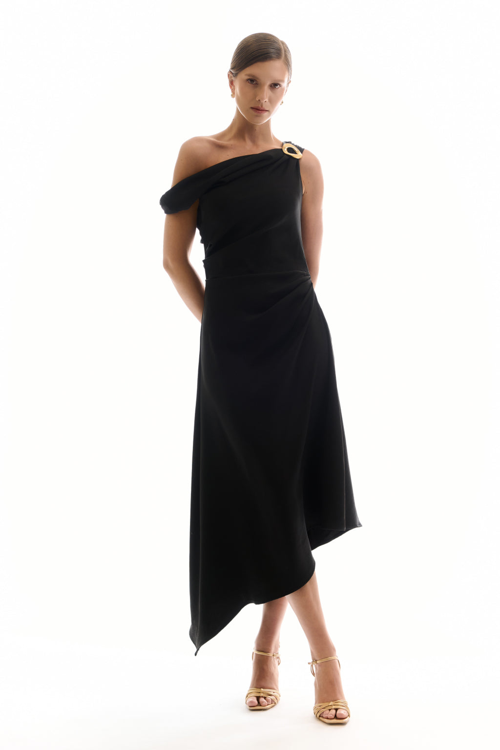 Woman wearing a black one-shoulder dress on a white background