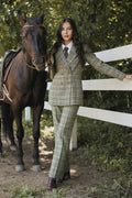 Woman in a plaid suit standing next to a horse in an outdoor setting