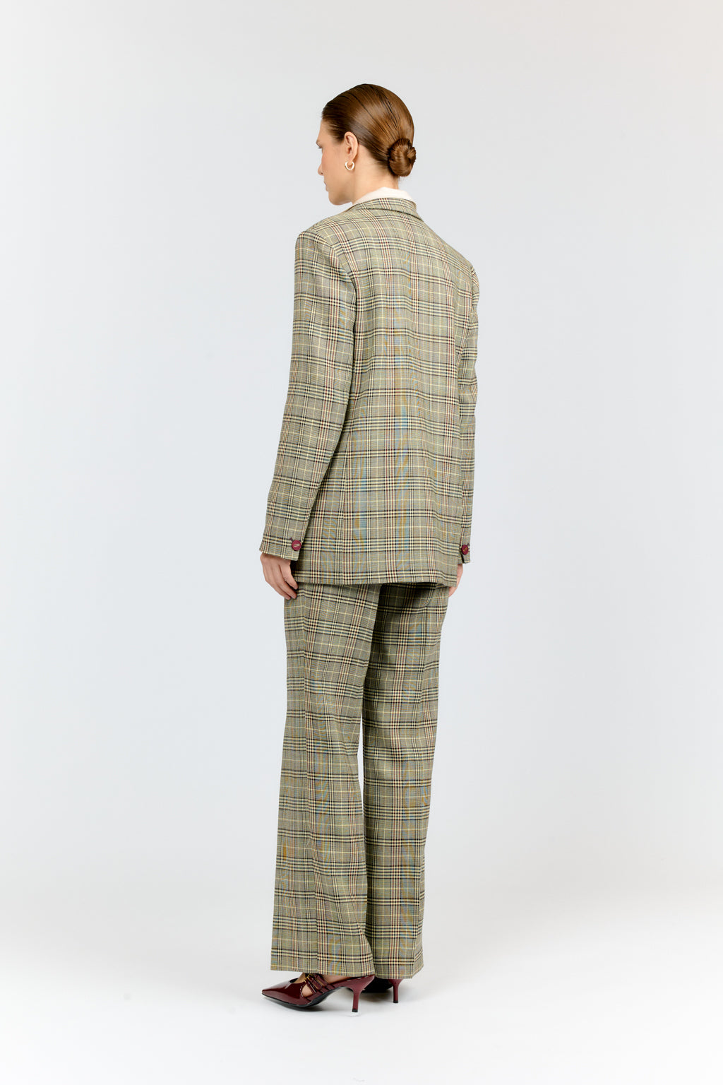 Person wearing a green plaid suit on a white background