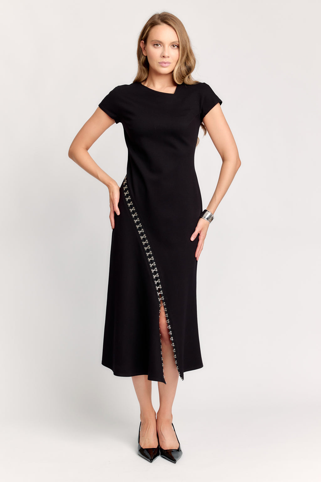 Black dress with side slits and decorative elements on a white background