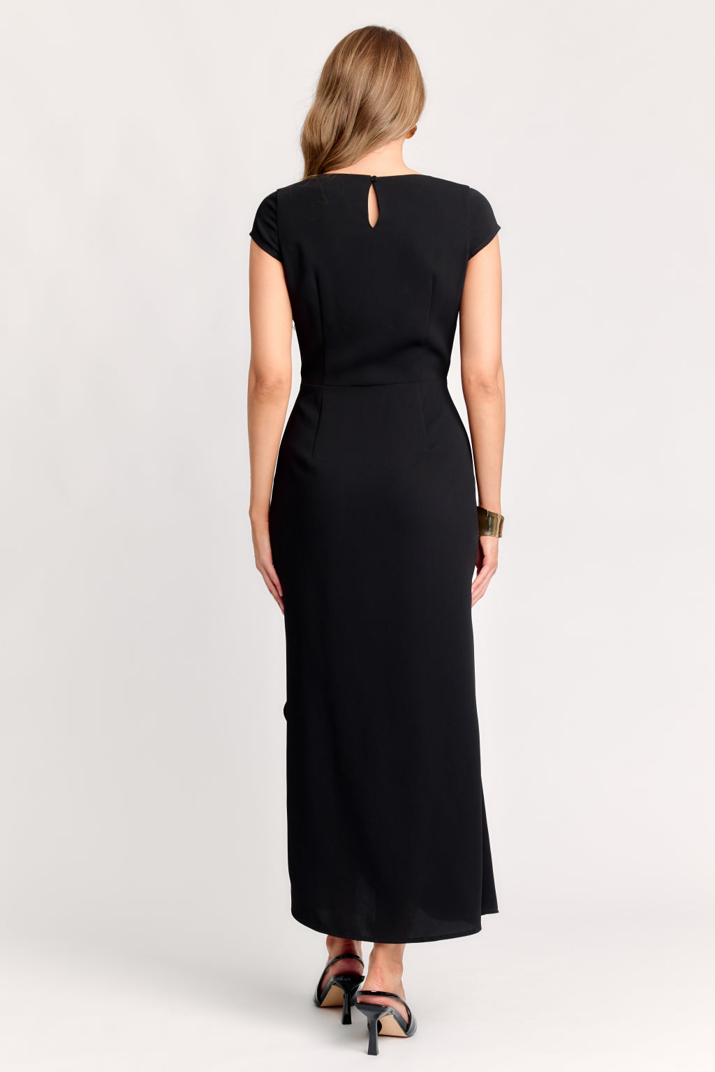 Woman wearing a black dress on a white background