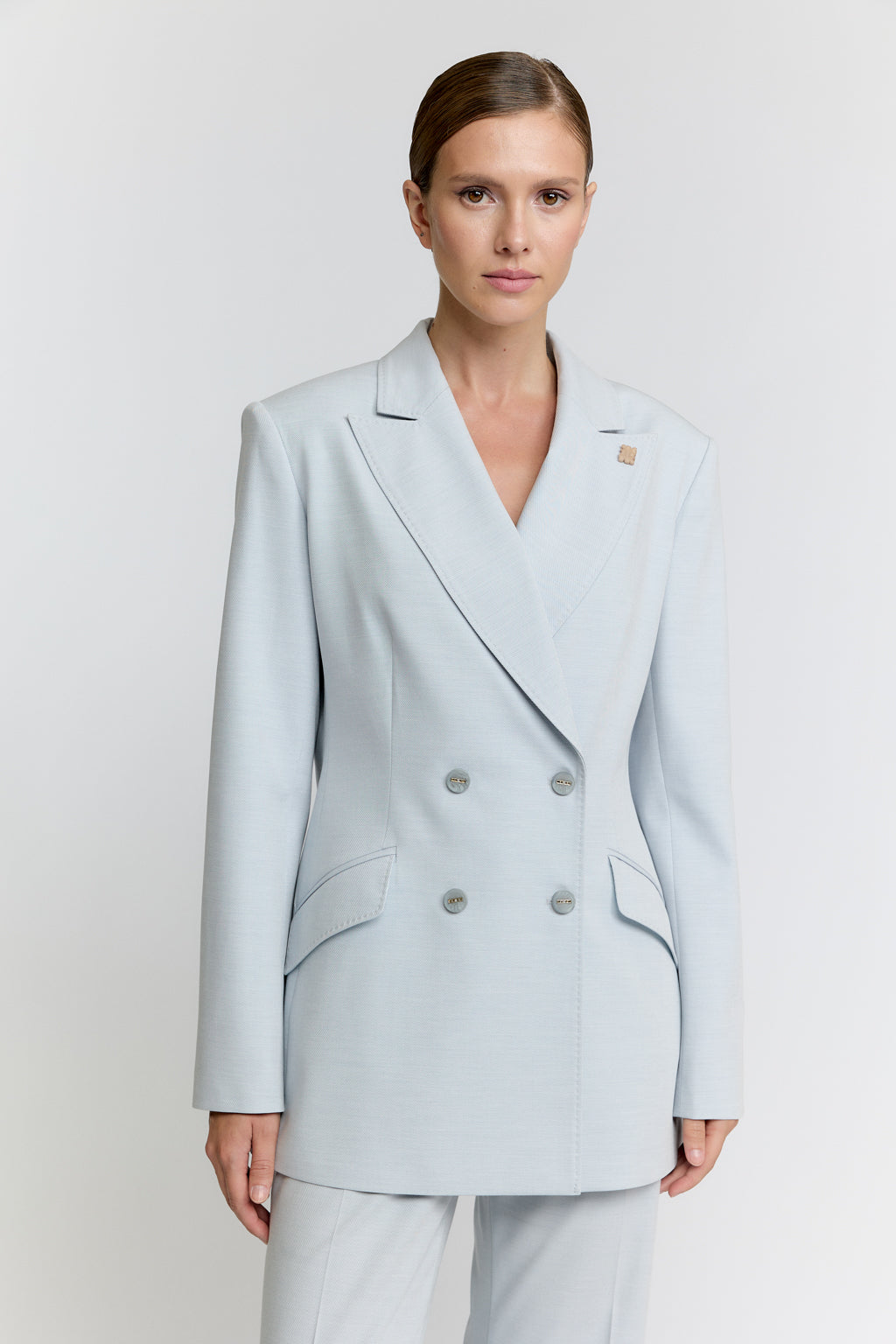 Light blue blazer worn by a model on a white background
