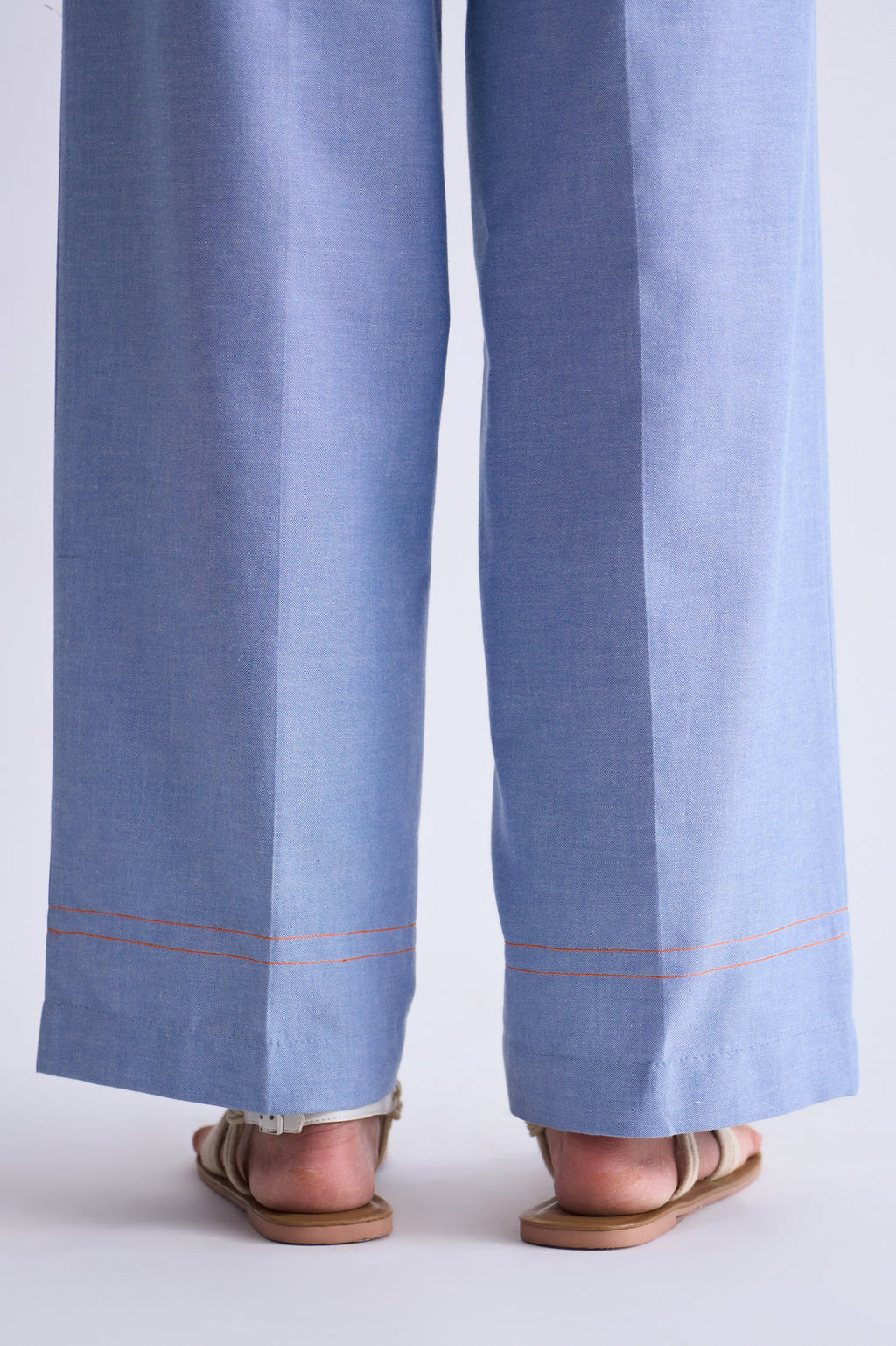 Light blue pants with a white border worn by a person on a white background