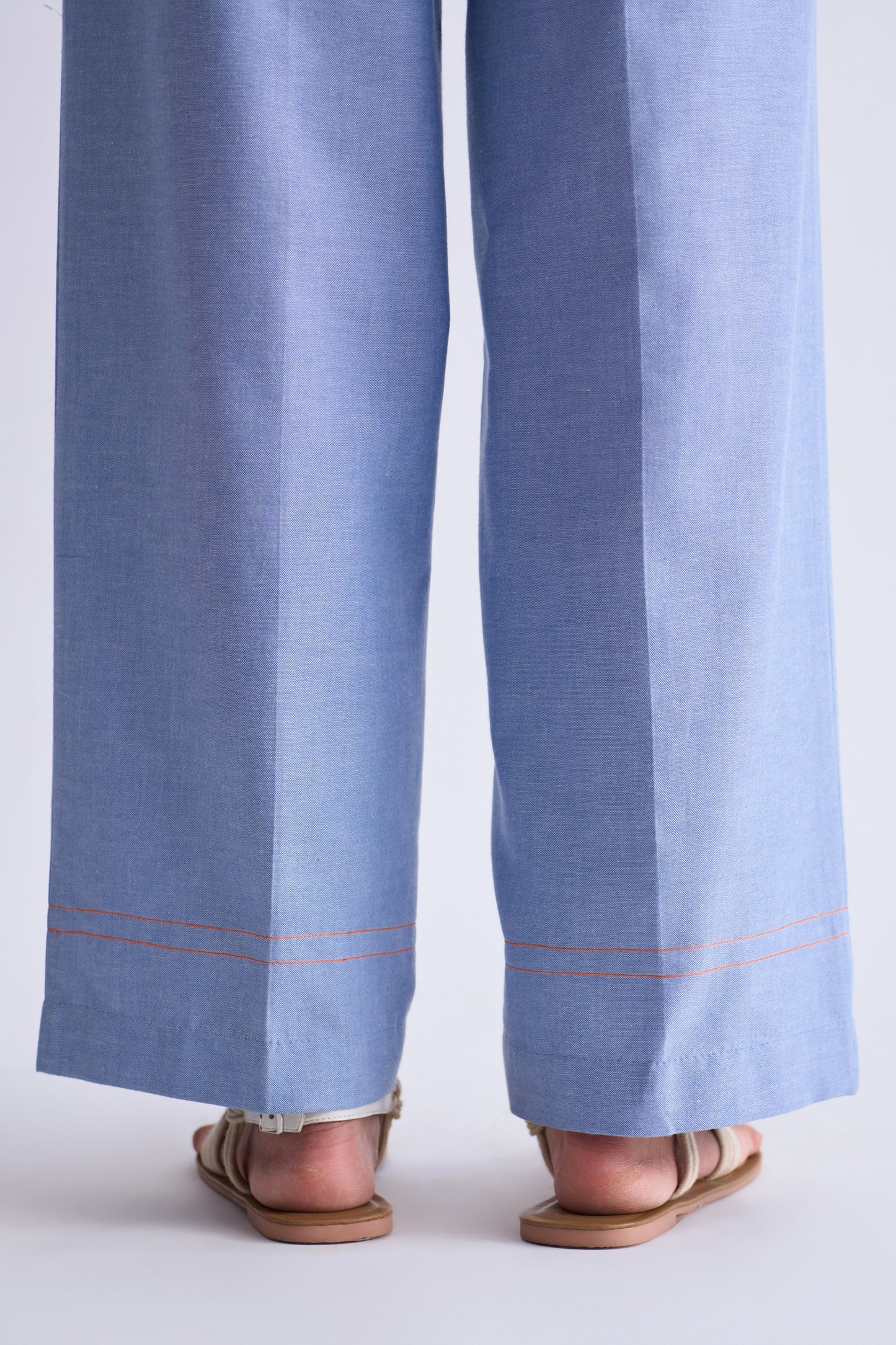 Light blue pants with a white border worn by a person on a white background