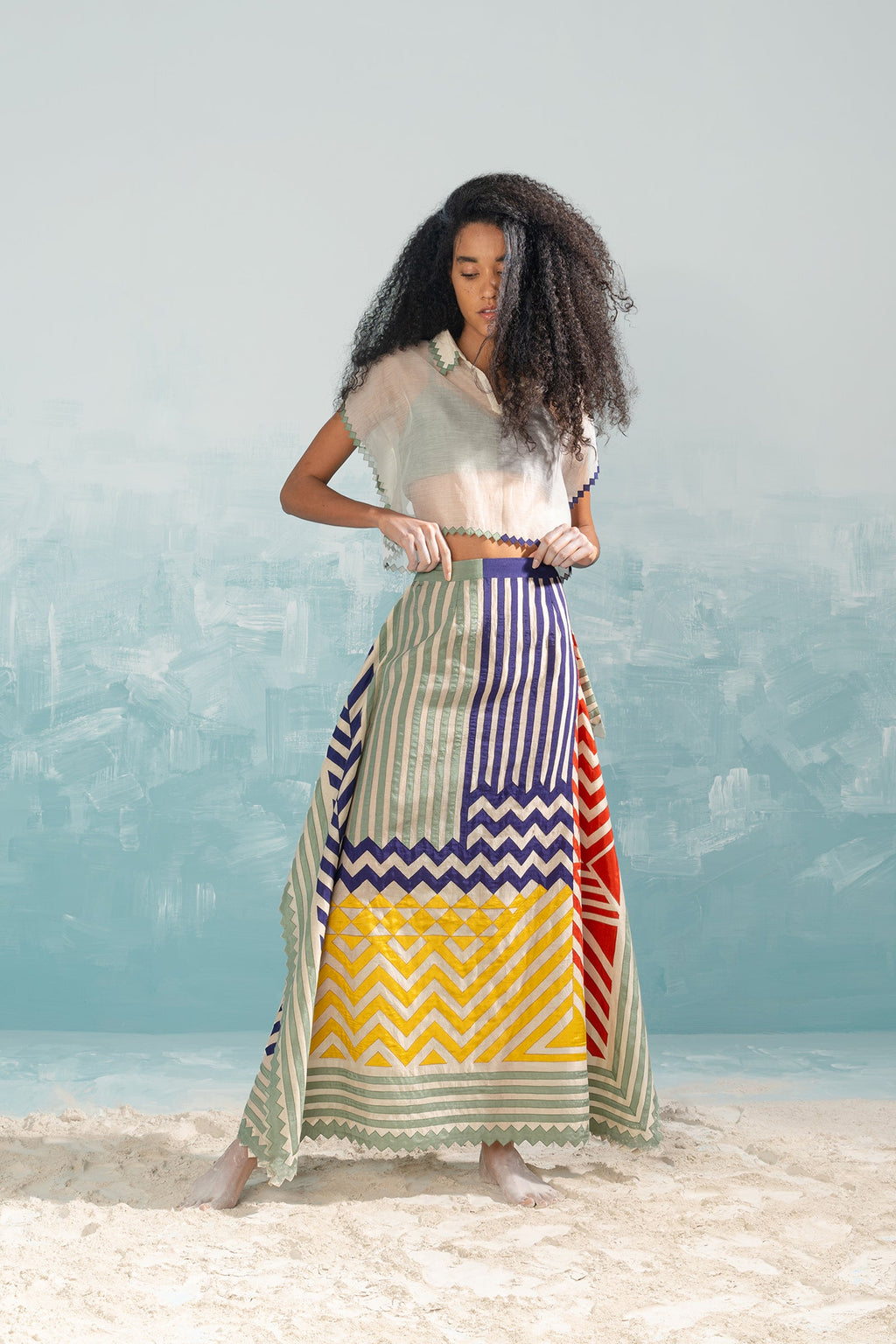 Woman wearing a colorful skirt with a white background