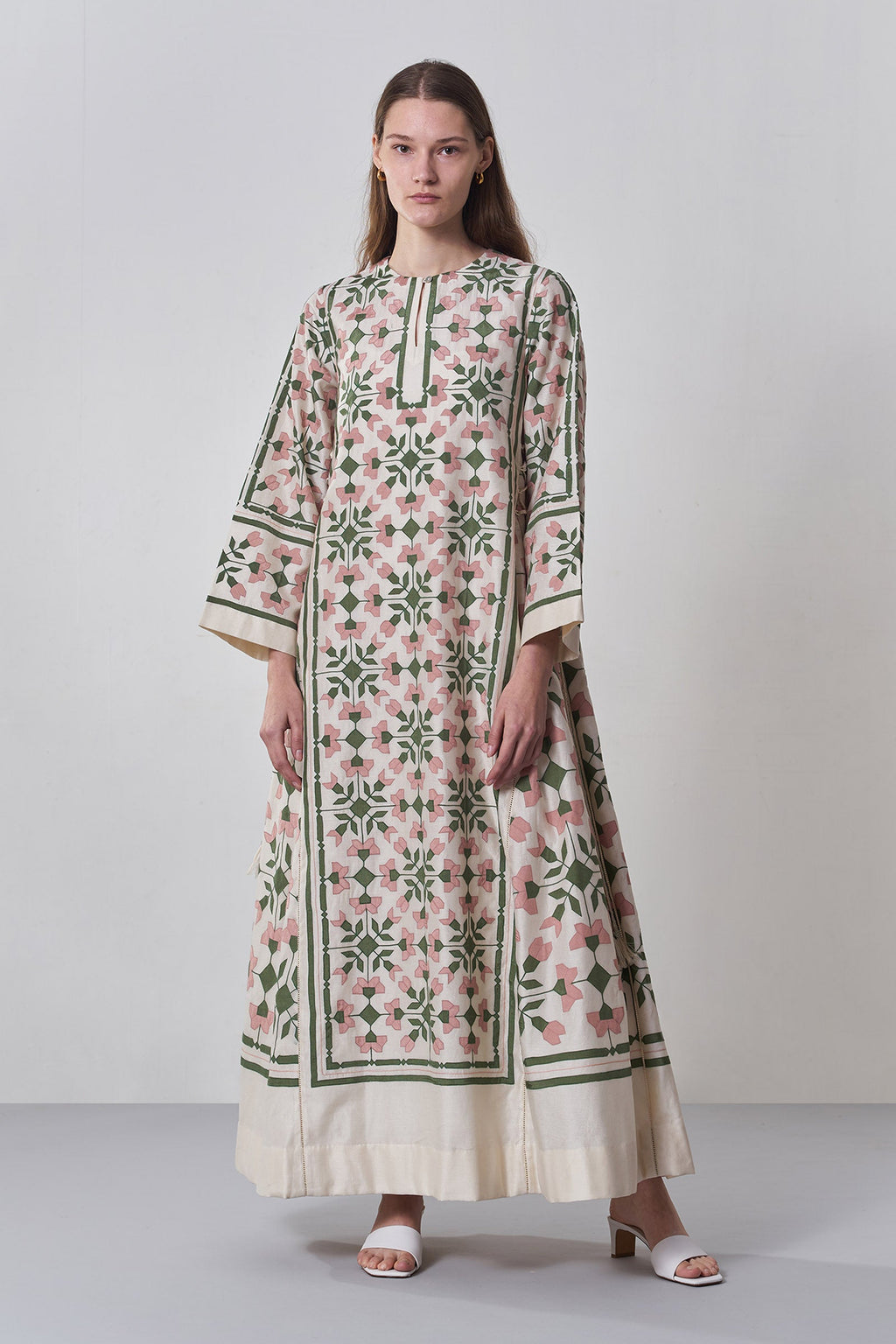 Woman wearing a floral dress with a white background