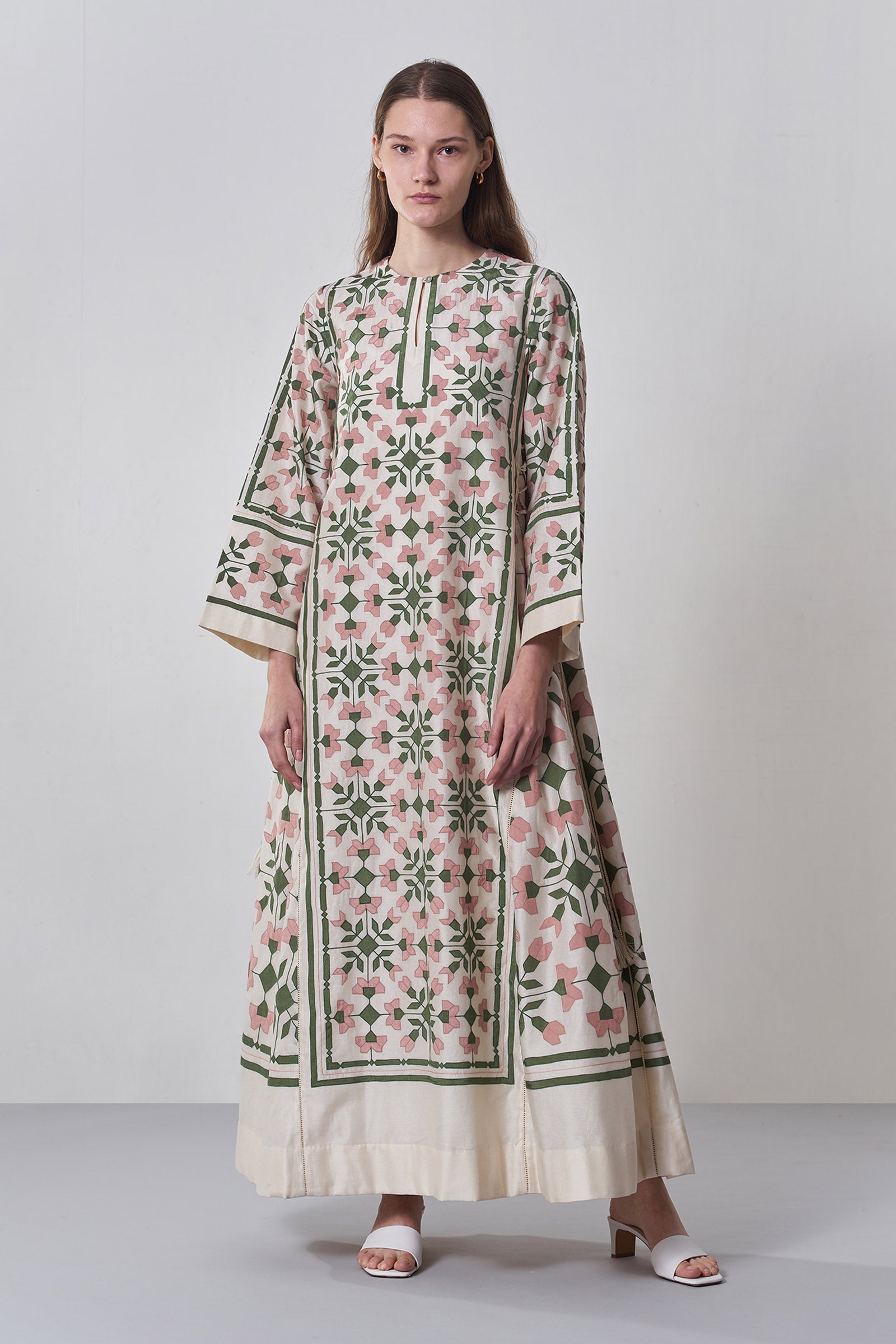 Woman wearing a floral dress with a white background