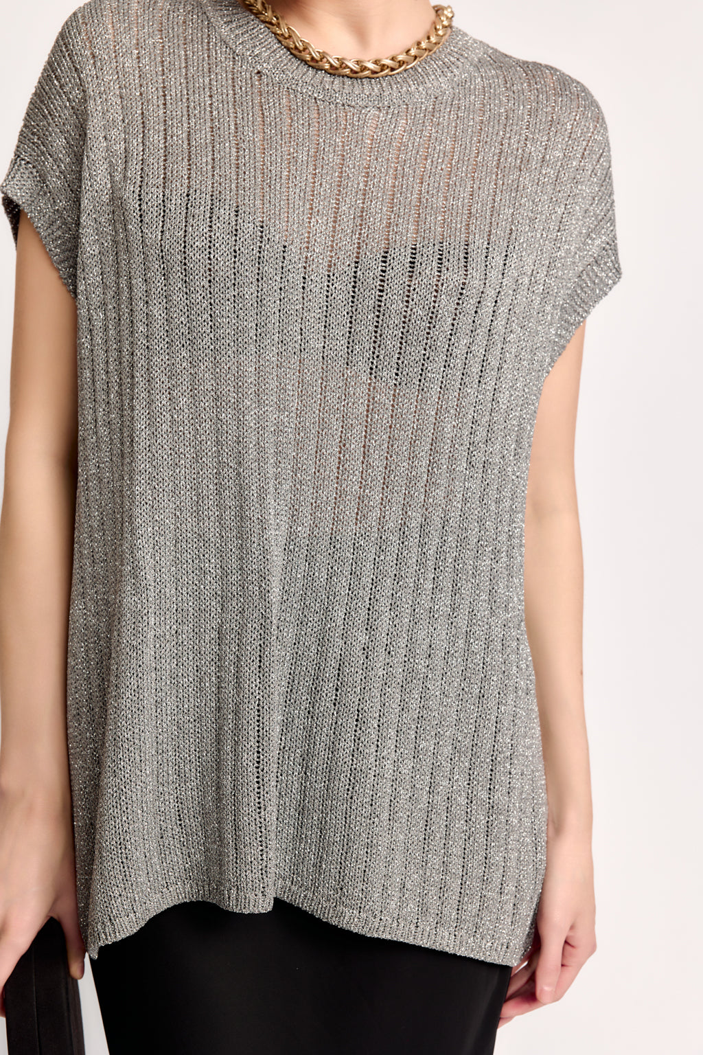 Gray ribbed knit sleeveless top worn by a person on a white background