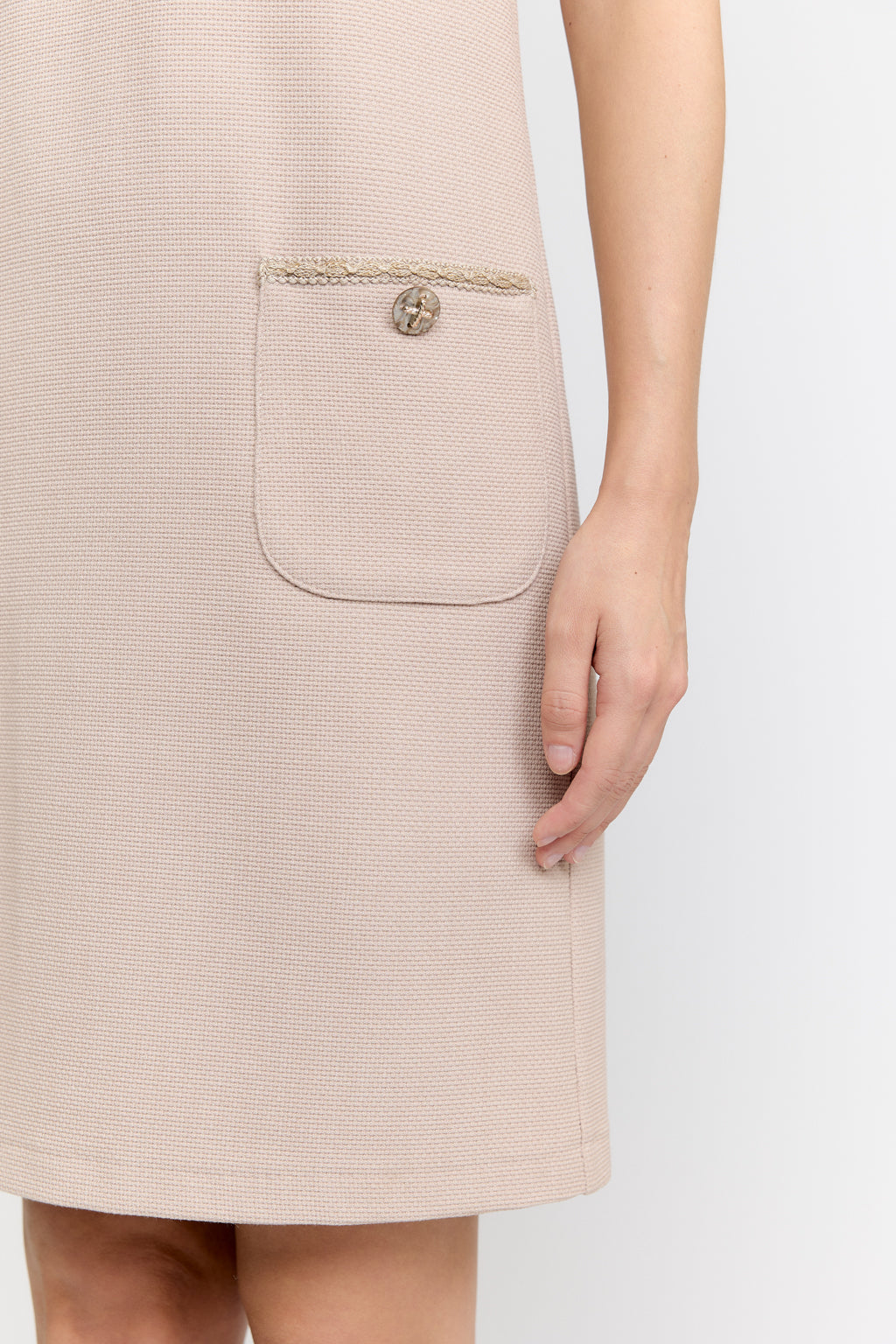 Beige dress with a pocket on a white background