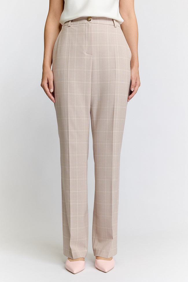 Woman wearing a beige suit on a white background Luxury Women's Wear | Custom-Made, Eco-Friendly Fashion