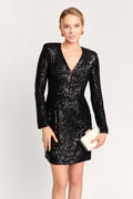 Woman wearing a black sequin dress on a white background
