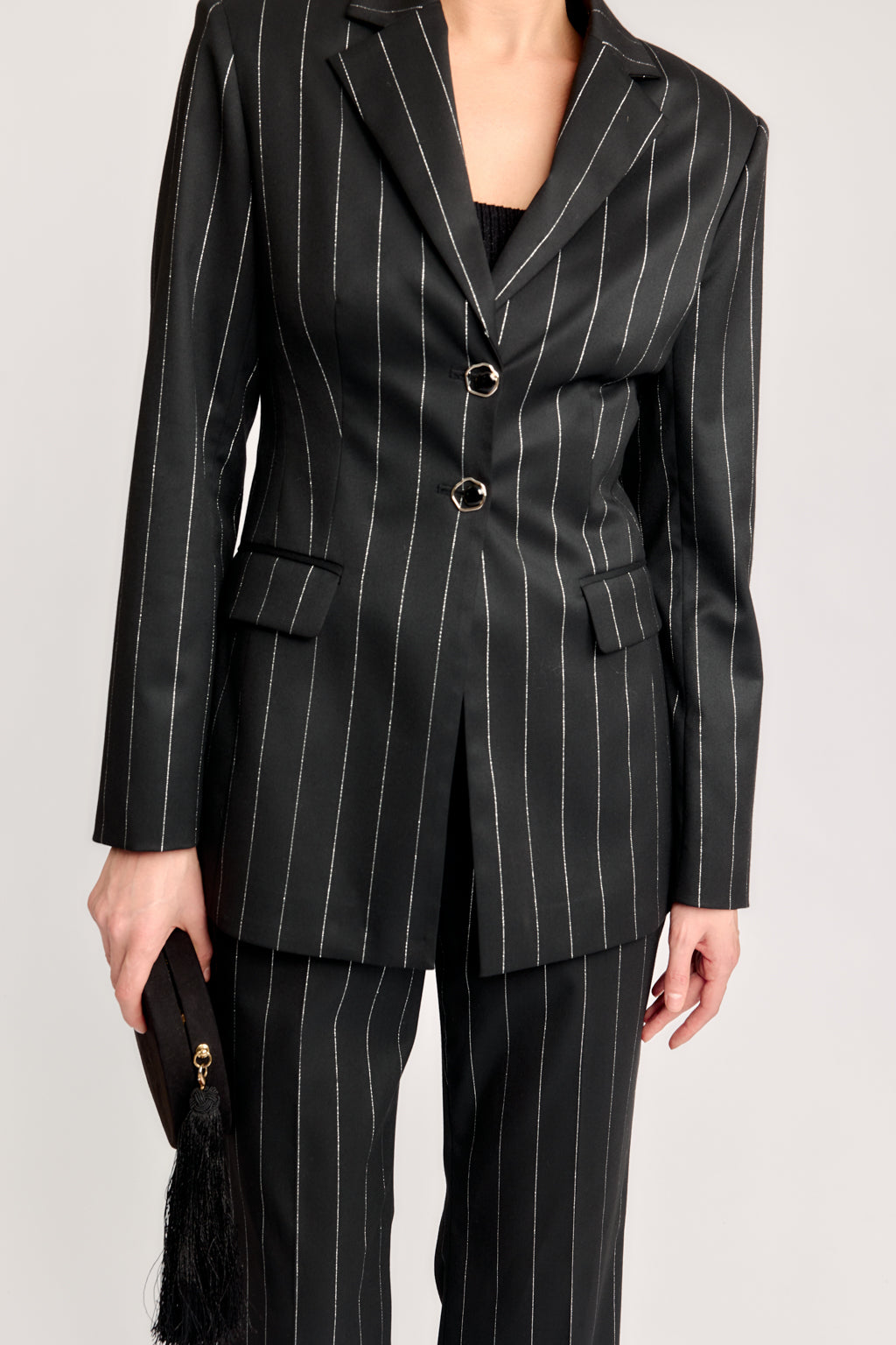 Black pinstripe suit with a plain background