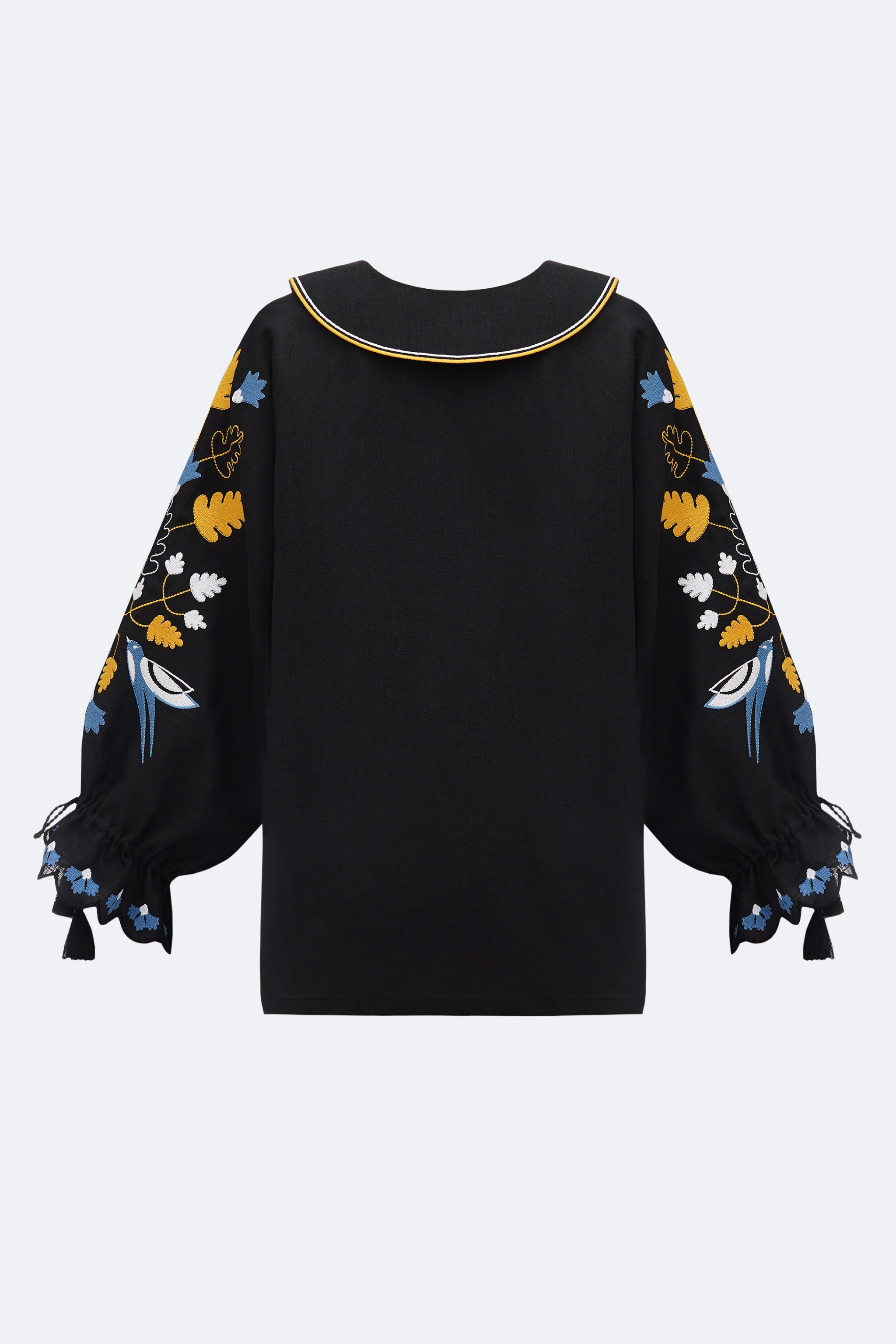 Black blouse with colorful floral patterns on sleeves against a white background