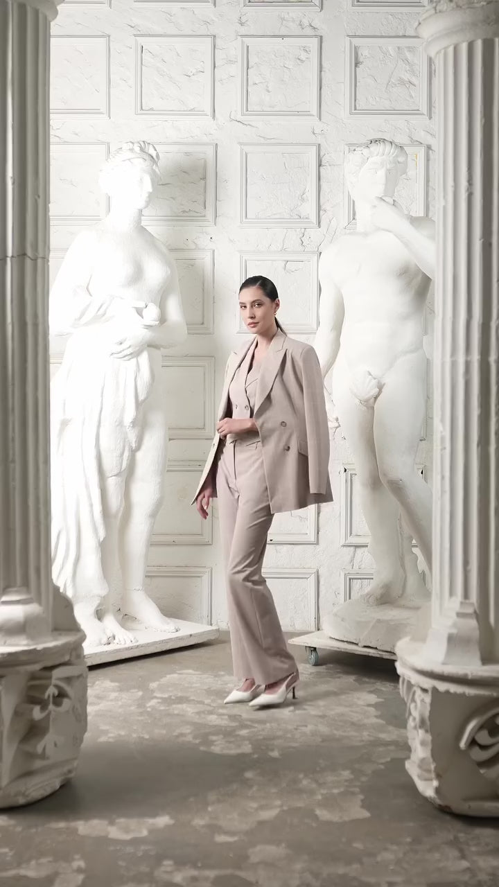 Woman wearing a beige suit on a white background Luxury Women's Wear | Custom-Made, Eco-Friendly Fashion